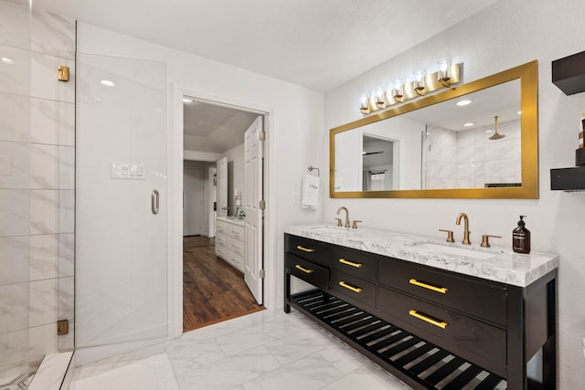 bathroom featuring vanity and an enclosed shower