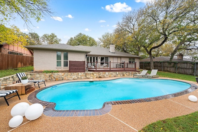 view of swimming pool featuring a wooden deck