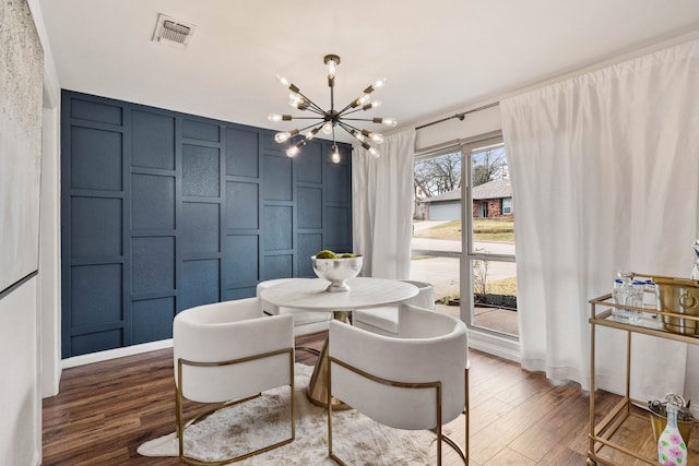 dining space featuring an inviting chandelier and dark hardwood / wood-style flooring