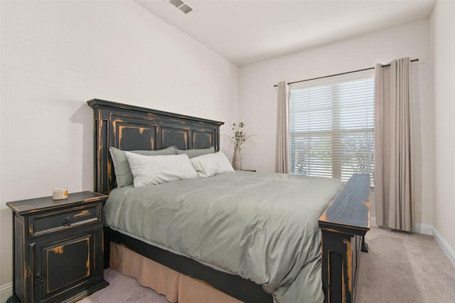 bedroom featuring light colored carpet