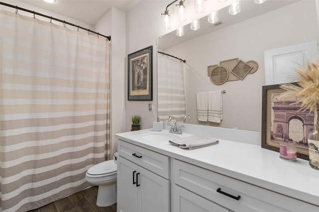 bathroom with hardwood / wood-style flooring, vanity, and toilet