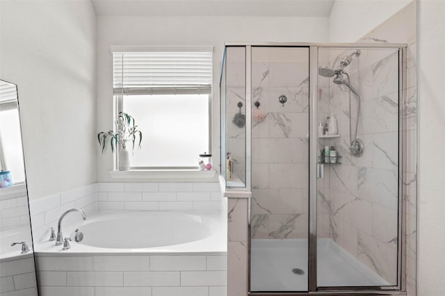 bathroom featuring separate shower and tub