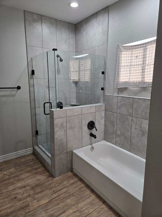 bathroom with wood-type flooring and separate shower and tub