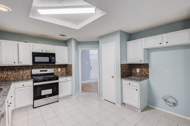 kitchen with backsplash, dark stone countertops, stainless steel range with gas stovetop, and white cabinets