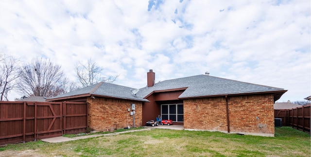 rear view of house featuring central AC unit, a yard, and a patio