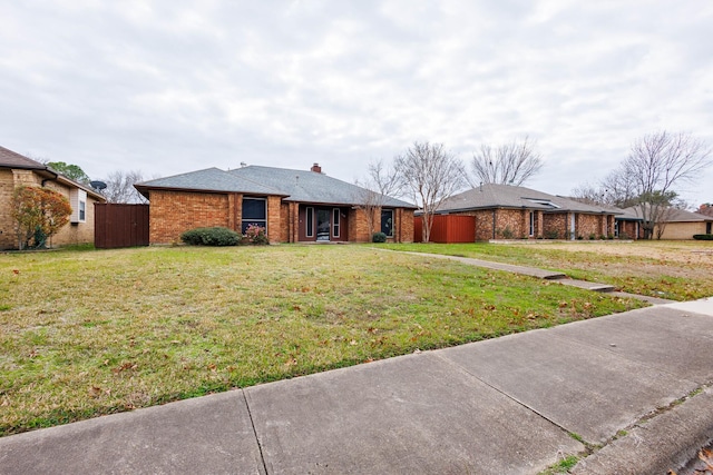 ranch-style home featuring a front yard