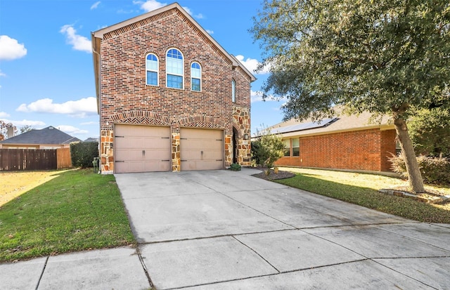 view of property with a garage and a front lawn