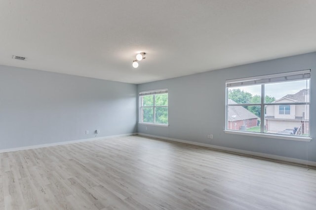 empty room with light hardwood / wood-style flooring