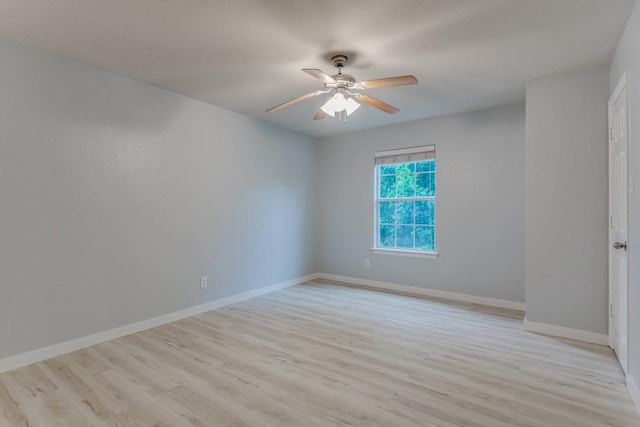 spare room with ceiling fan and light hardwood / wood-style floors