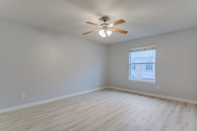 spare room with ceiling fan and light wood-type flooring