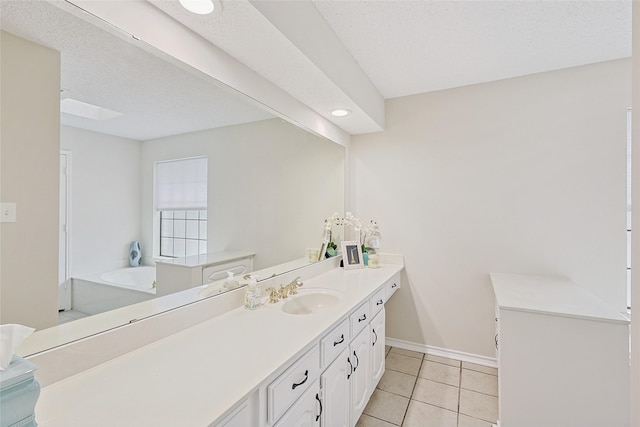 bathroom with vanity, a bath, tile patterned floors, and a textured ceiling