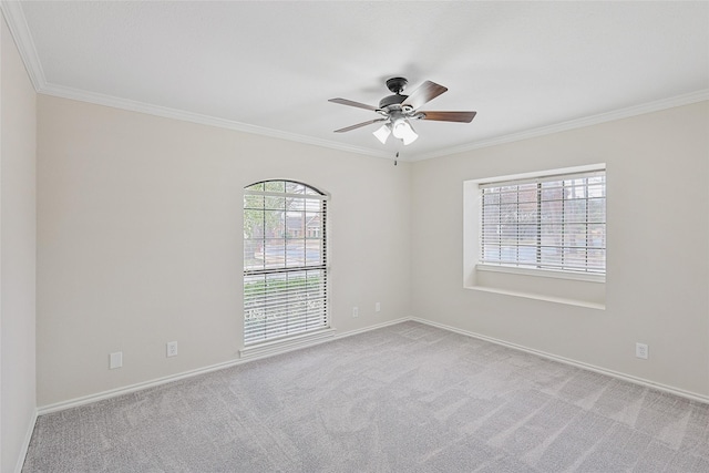 unfurnished room with crown molding, light colored carpet, and ceiling fan