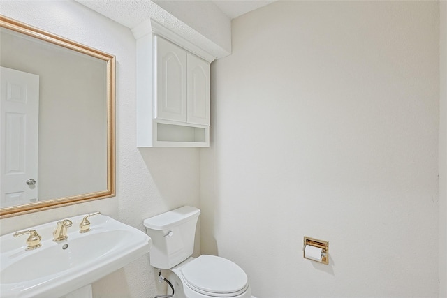 bathroom featuring sink and toilet