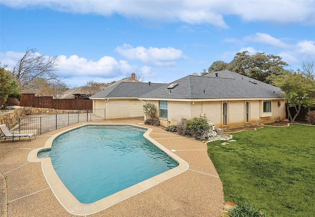 view of swimming pool featuring a yard and a patio area