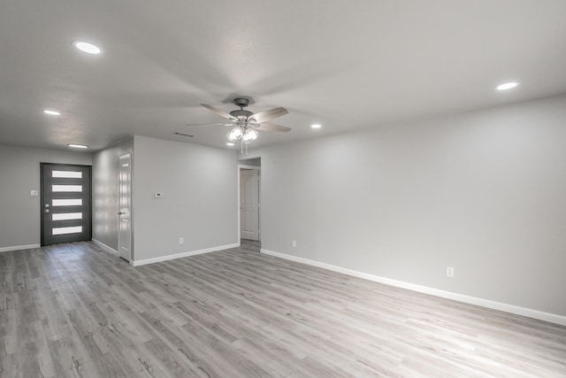 unfurnished living room with ceiling fan and light wood-type flooring