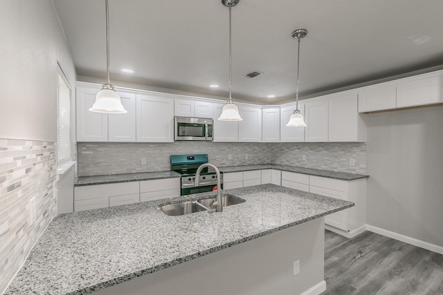 kitchen with white cabinetry, sink, hanging light fixtures, light stone counters, and stainless steel appliances