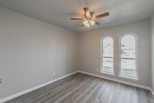 empty room featuring hardwood / wood-style floors, a textured ceiling, and ceiling fan