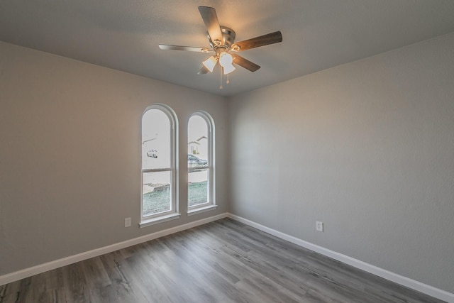 empty room with ceiling fan and wood-type flooring