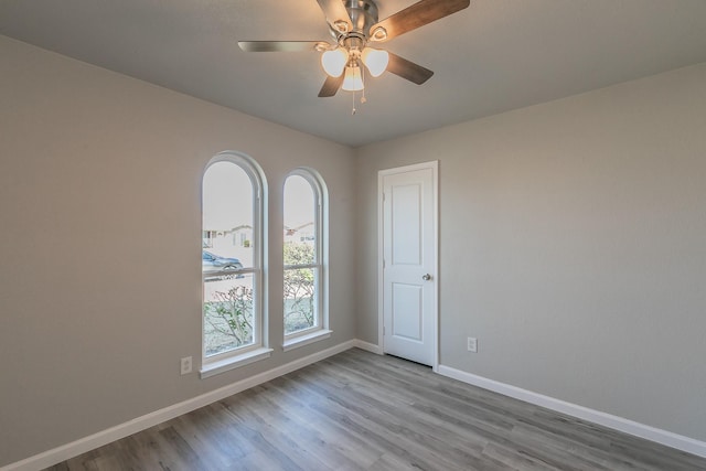 unfurnished room with light hardwood / wood-style floors and ceiling fan