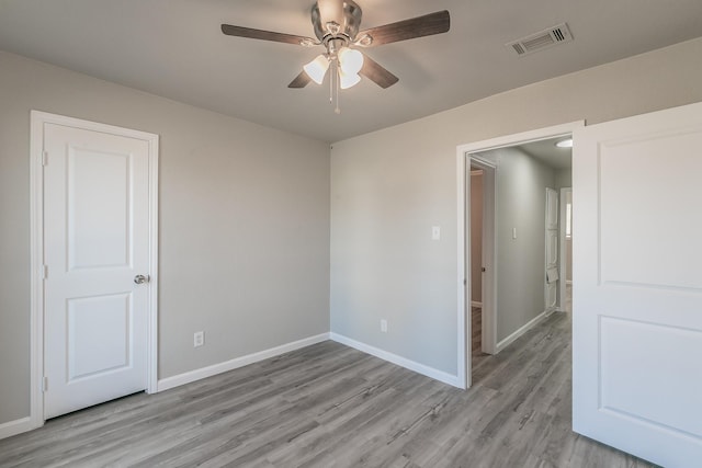 unfurnished room with light hardwood / wood-style floors and ceiling fan