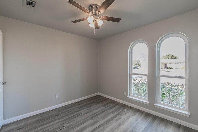 unfurnished room with ceiling fan and hardwood / wood-style floors