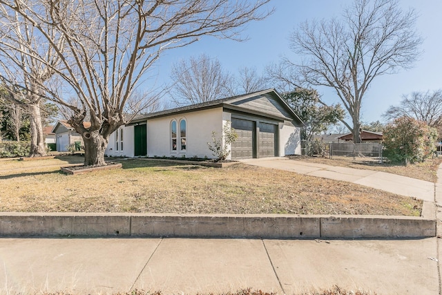 single story home with a garage and a front lawn