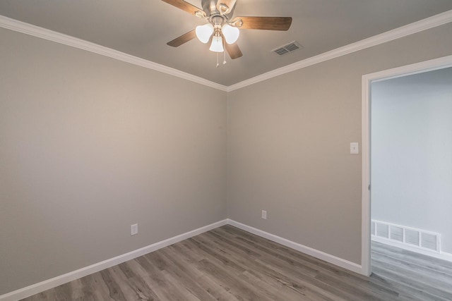 empty room with hardwood / wood-style flooring, ceiling fan, and crown molding