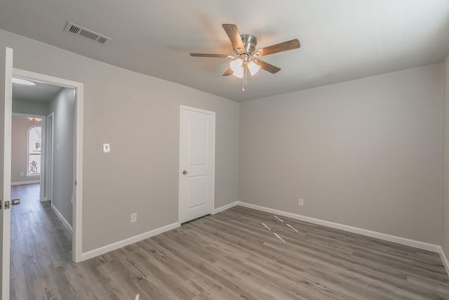 spare room with hardwood / wood-style floors and ceiling fan