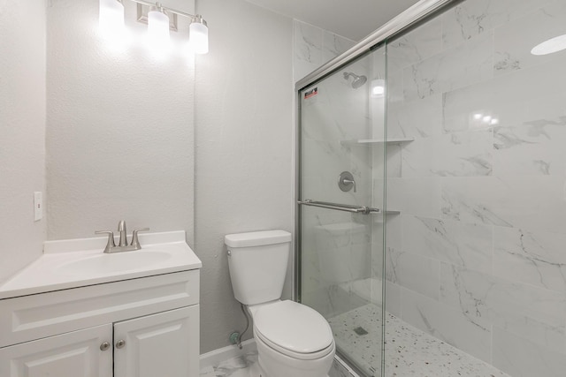 bathroom with vanity, toilet, and walk in shower