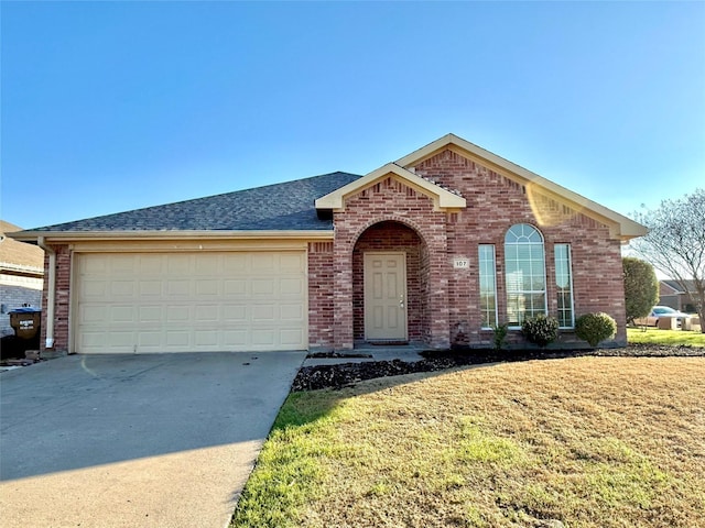 view of front of home with brick siding, roof with shingles, concrete driveway, an attached garage, and a front lawn