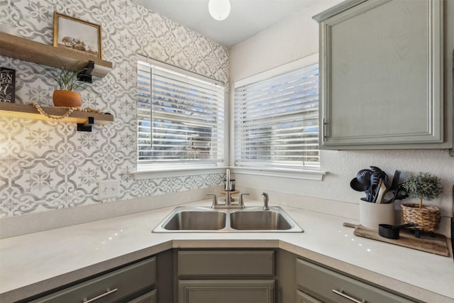 kitchen featuring gray cabinets, sink, and a wealth of natural light