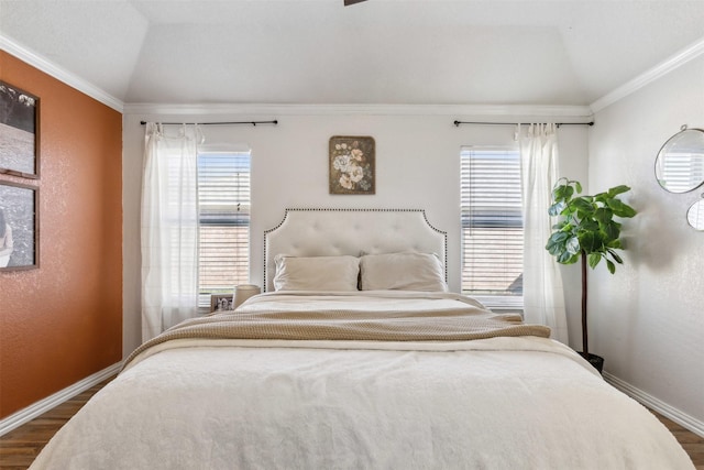 bedroom with dark hardwood / wood-style flooring, ornamental molding, and lofted ceiling