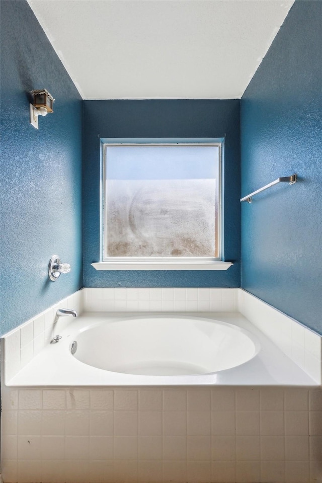 bathroom with tiled tub