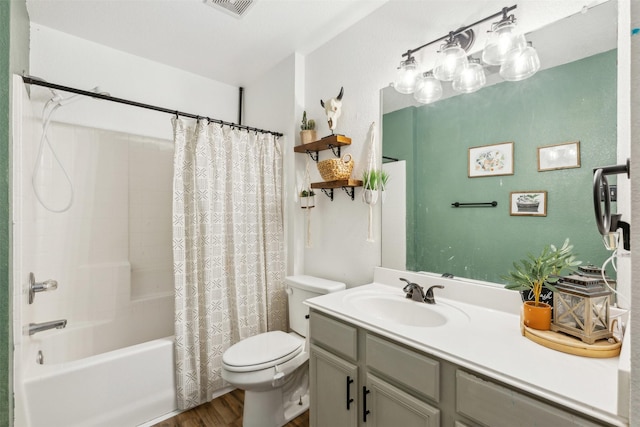 full bathroom with vanity, hardwood / wood-style floors, toilet, and shower / bath combo