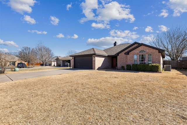 view of front of property with a garage and central air condition unit