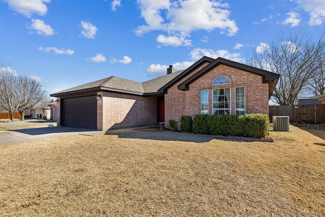 ranch-style house featuring a garage and central AC