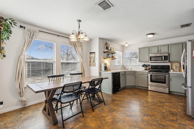 dining room featuring an inviting chandelier, sink, and a textured ceiling