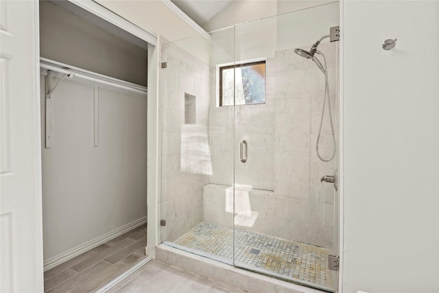 bathroom with lofted ceiling and walk in shower