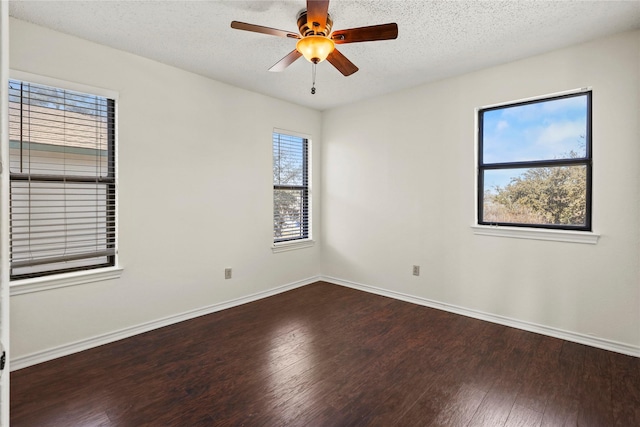 spare room with ceiling fan, dark hardwood / wood-style floors, and a textured ceiling