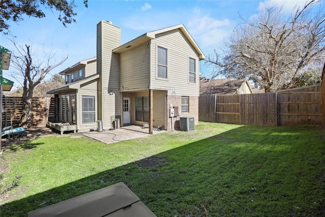 back of house with a yard, central AC, and a patio