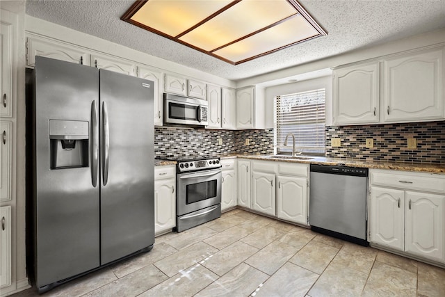 kitchen with stainless steel appliances, sink, and white cabinets