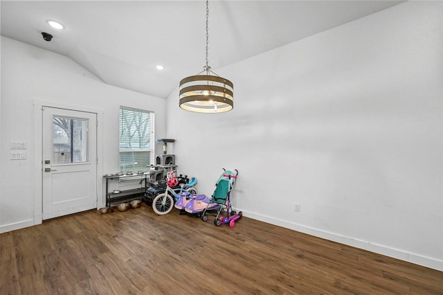 playroom with hardwood / wood-style flooring, vaulted ceiling, and a chandelier