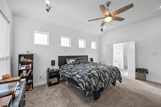 carpeted bedroom featuring multiple windows, vaulted ceiling, ceiling fan, and ensuite bathroom