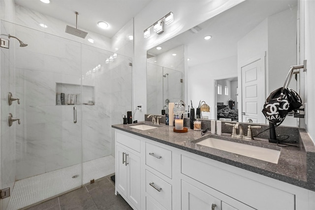 bathroom with an enclosed shower, vanity, and tile patterned floors