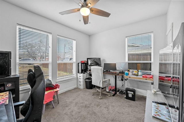 office space featuring light carpet and ceiling fan