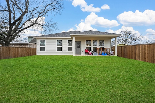 rear view of house with a yard