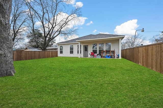 back of house featuring a yard and a patio area