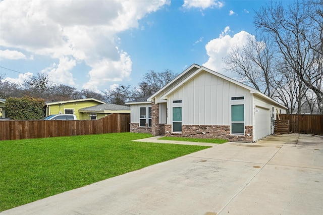 view of front of property with a garage and a front lawn