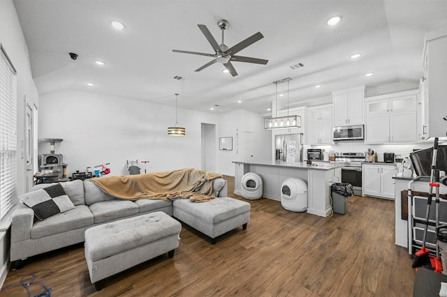 living room featuring lofted ceiling, dark wood-type flooring, and ceiling fan