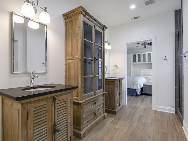 bathroom featuring vanity, an enclosed shower, and hardwood / wood-style floors